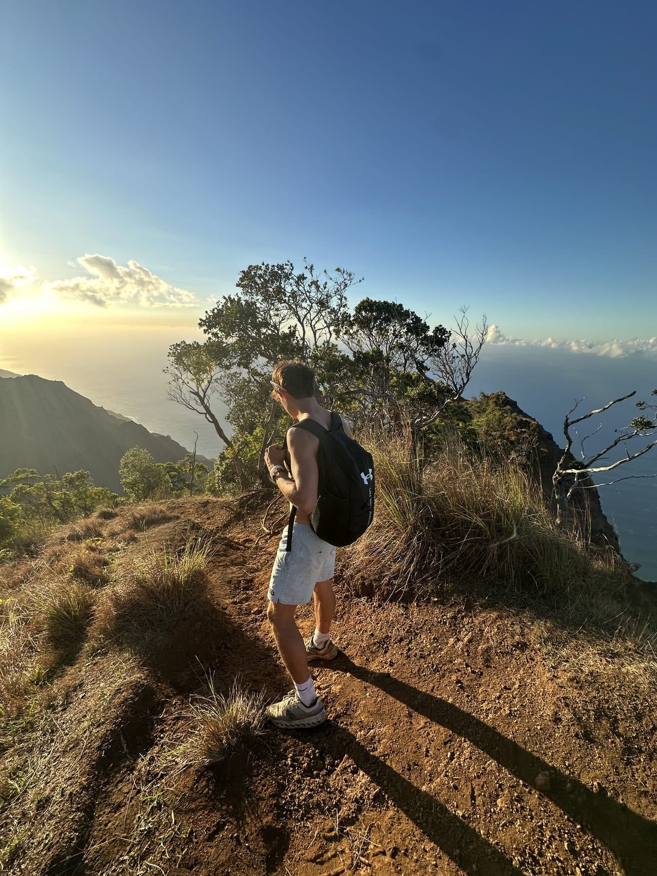 Jeffrey on a clifftop ridge trail above the ocean at golden hour